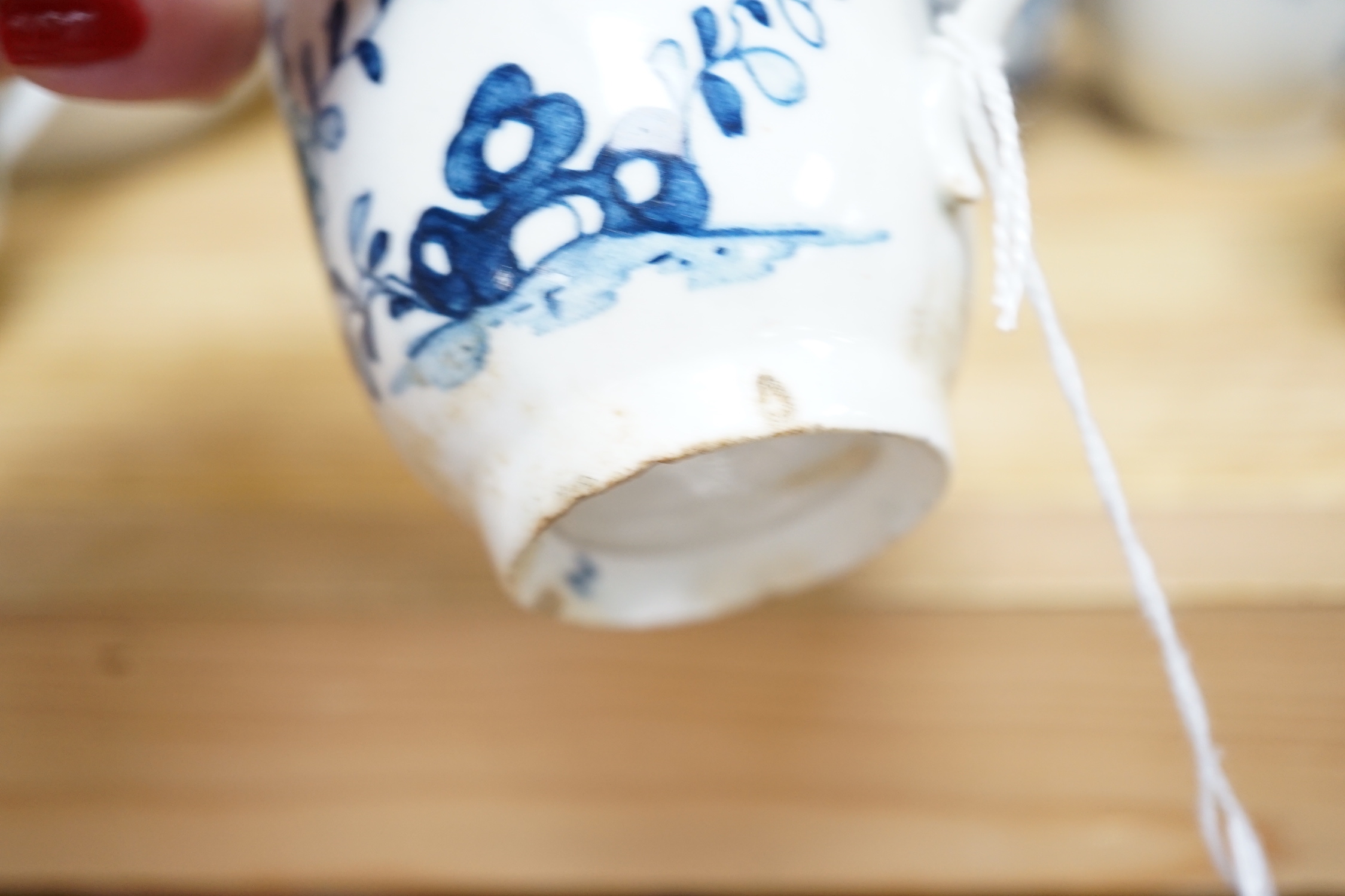 Seven various English porcelain coffee cups, including two Bristol enamelled with green floral sprays, two Bow painted in underglaze blue with a bird in a Chinese garden, and three Worcester/Bow in underglaze blue.